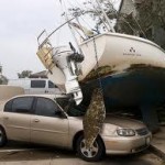 boat sitting on top of a car after storm