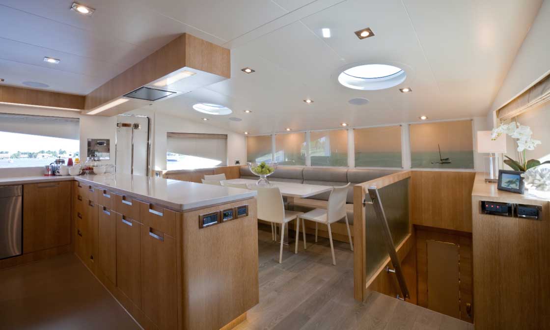 The galley occupies a sizable space forward on the main deck. Not visible is the primary cooking area, which runs lengthwise, to port. Since Andrea IV is a yacht enjoyed by multiple generations, it was important to the owners to have abundant areas where they can spend time together. Other buyers might prefer their master suite here and a smaller galley. 