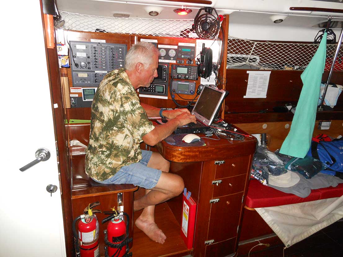 When Vern claims the navigation station while the weather is still fair, he logs, “Aft of my “bed” in the settee berth is the navigation station, the nerve center of the boat. Our VHF radio is turned on around the clock to monitor channels 16 and 9. Even out here we could have a need to speak with the officer in charge on the bridge of a freighter to ensure they are aware of our presence and to ensure a safe distance encounter. As this update is written, Brian is sleeping, Mike is driving, and Rob is making coffee. Everyone has a job to do at all times aboard the boat – even if it is sleeping to ensure fatigue does not incapacitate crew.” 